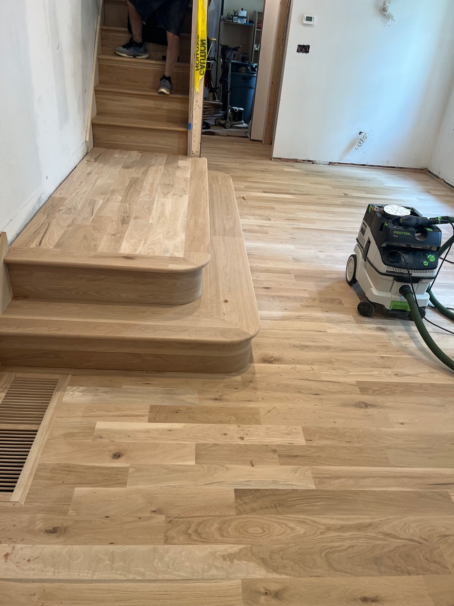Hardwood flooring installation with custom bullnose stairs by East Coast Floors